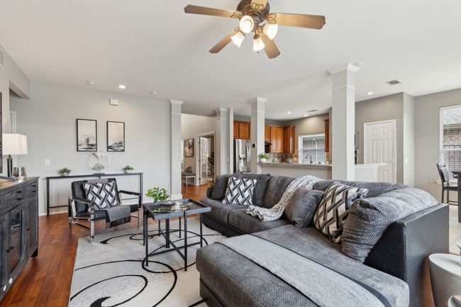 Living area featuring ornate columns, dark wood-type flooring, recessed lighting, and ceiling fan | Image 13