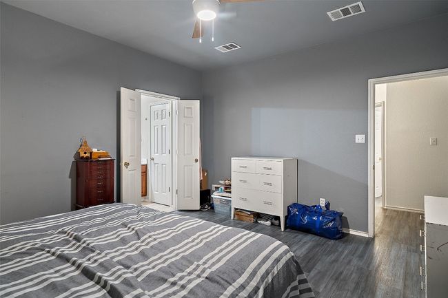 Spacious primary suite on the back of the house for added privacy offers a walk in closet, dual vanities, linen closet plus a window over the shower and tub providing natural light. | Image 23