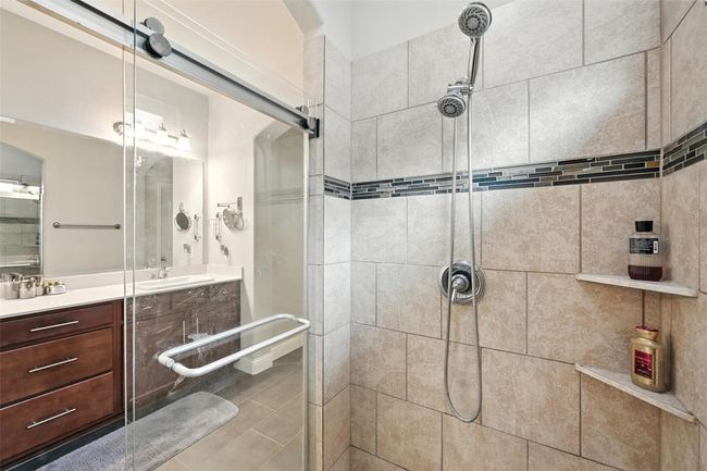 Primary Bathroom with a stall shower, vanity, and tile patterned floors | Image 18