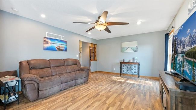 Living area with a ceiling fan, light wood-type flooring, and recessed lighting | Image 4