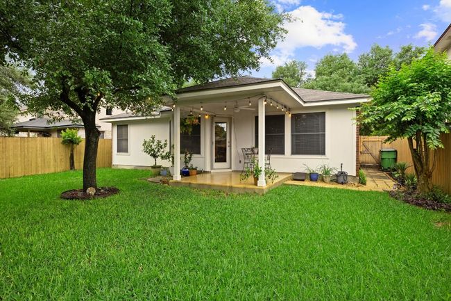 Shaded backyard with a covered patio area, ceiling fan | Image 21
