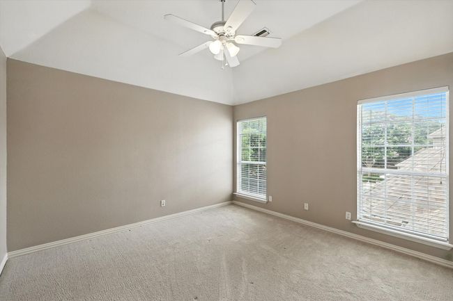 Upstairs bedroom with vaulted ceiling, carpet flooring, and ceiling fan | Image 19