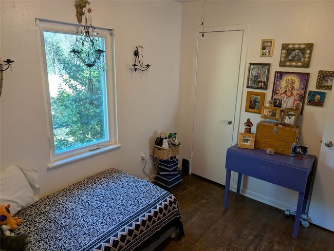 Bedroom featuring multiple windows and dark wood-type flooring | Image 16