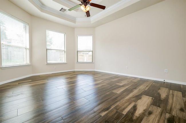 Huge bay windows line this wall in your luxurious primary suite on the 1st level. | Image 12