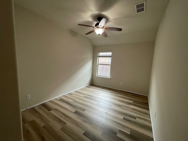 Unfurnished room with a ceiling fan and wood finished floors | Image 21