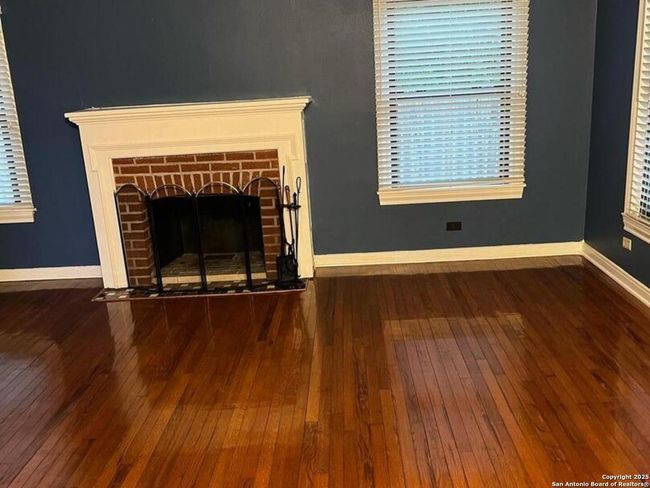 Living room area, wood burning fireplace | Image 7