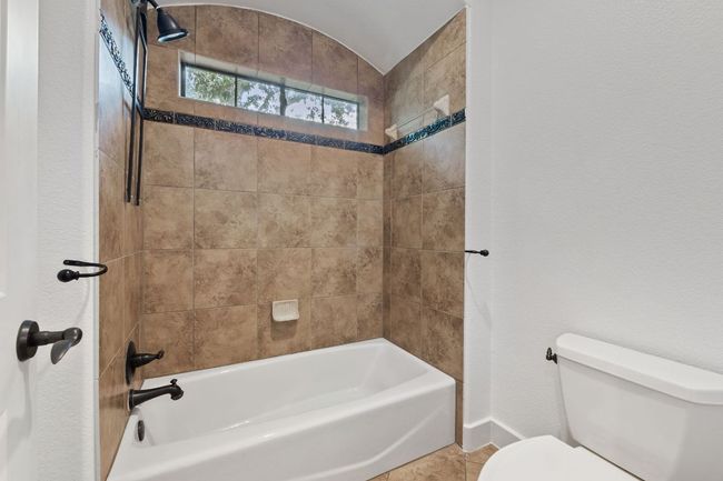 Full bathroom featuring bathtub / shower combination and tile patterned flooring | Image 27