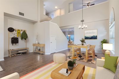 Inside you will find soaring two-story ceilings in the open concept living and dining area, seamlessly flowing into the kitchen and family room. | Image 2