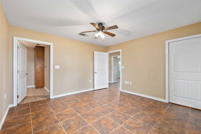 Unfurnished bedroom featuring tile patterned flooring and a ceiling fan | Image 21