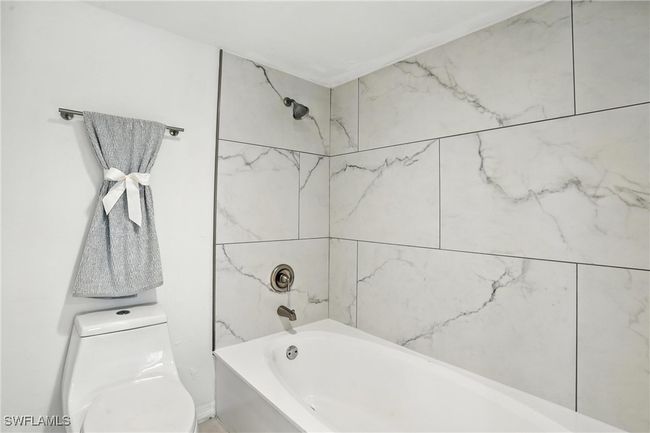Full bathroom featuring washtub / shower combination and toilet | Image 29