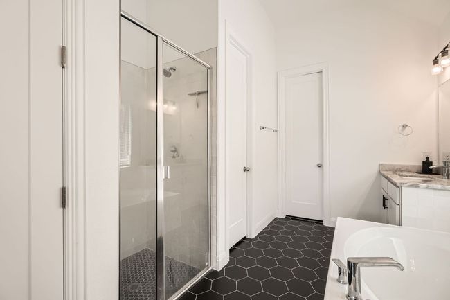 Full bathroom with a stall shower, vanity, a garden tub, and tile patterned flooring | Image 20