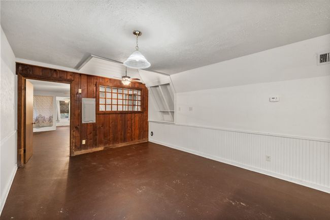 Unfurnished dining area featuring painted concrete flooring | Image 12