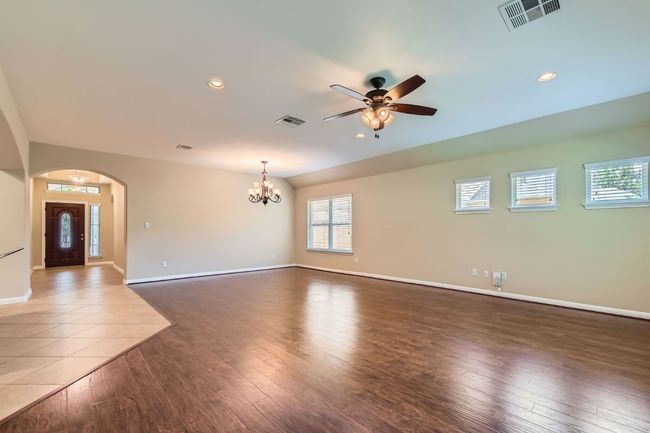 Living and Dining room with ceiling fan, a chandelier, arched walkways, recessed lighting, and hardwood / wood-style flooring | Image 10