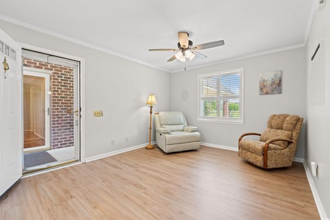 Sitting room featuring light wood-type flooring, ornamental molding, and ceiling fan | Image 36