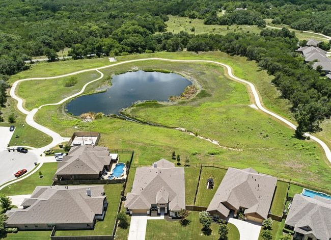 Aerial view of property's location featuring a heavily wooded area and a nearby body of water | Image 37