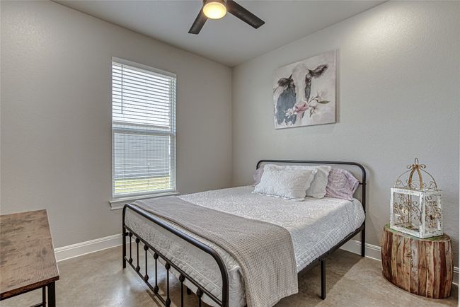 Bedroom featuring a ceiling fan | Image 17