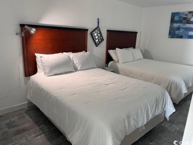 Bedroom with wood finished floors and baseboards | Image 11