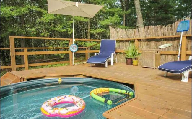 View of pool featuring a hot tub and a deck | Image 18