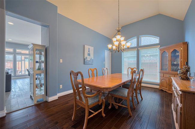 Dine in uncrowded comfort in this oversize Dining Room with wood floors. | Image 10