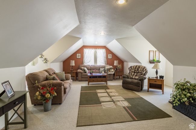 Bonus room with vaulted ceiling and carpet floors | Image 22