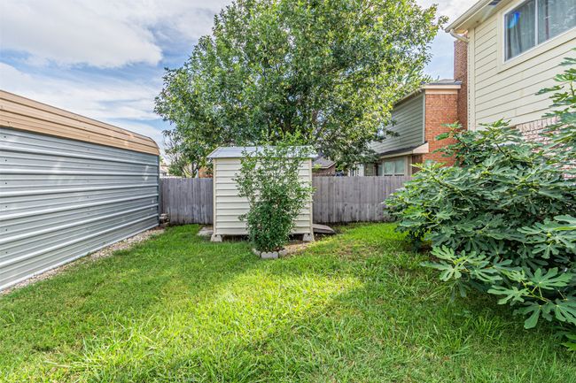 Fenced backyard featuring a shed | Image 37
