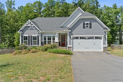 Craftsman-style ranch home with double-width driveway and two-car garage with direct entry | Image 1