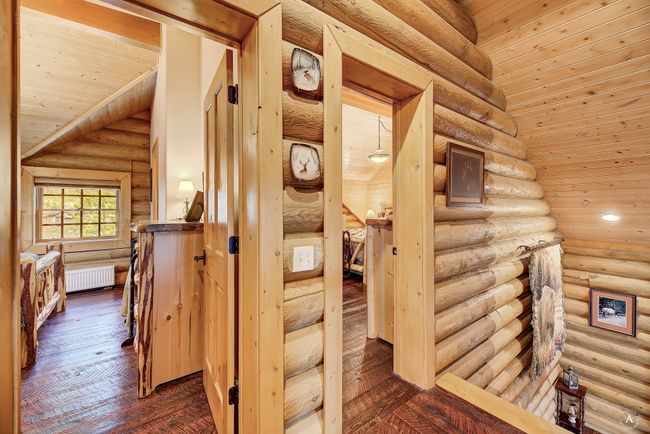 Hallway with radiator heating unit, wooden ceiling, rustic walls, dark wood-style floors, and recessed lighting | Image 24
