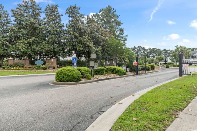 View of street with a gate, a gated entry, and curbs | Image 30