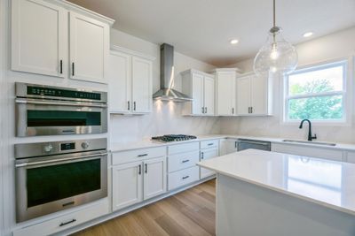 (Photo of an inventory home, actual homes finishes will vary) The gourmet kitchen features a large center island, quartz countertops, LVP floors, stainless steel appliances, and more! | Image 2