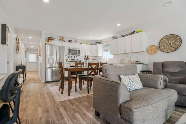 Living area with recessed lighting and light wood-style flooring | Image 10
