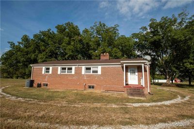 View of side of home featuring central AC unit and a yard | Image 3