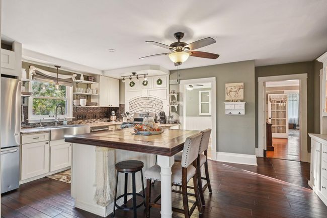 The heart of the home! The current owners did an extensive remodel in this room. The doorway on the left leads to the room currently used as the office, and the doorway on the right leads to the formal dining room. | Image 11