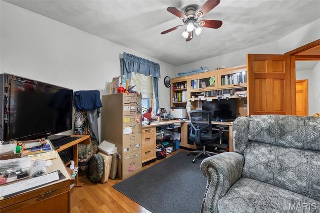 Office featuring a ceiling fan and light wood-style floors | Image 79