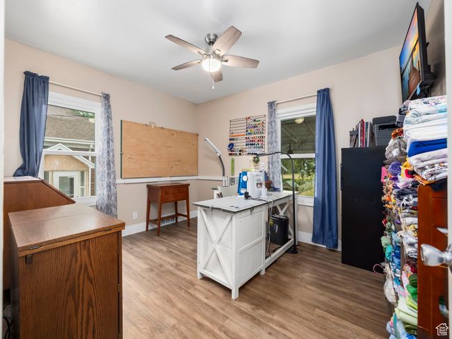 Office space with ceiling fan and light wood finished floors | Image 8