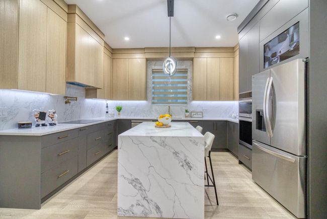 Kitchen with appliances with stainless steel finishes, modern cabinets, light brown cabinetry, and recessed lighting | Image 10
