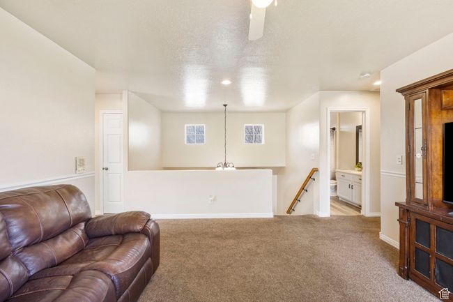 Sitting room featuring carpet floors, baseboards, and an upstairs landing | Image 20
