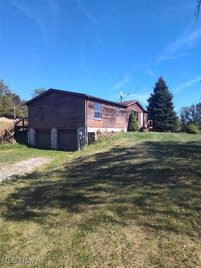 Rear view of property with a garage and a lawn | Image 3