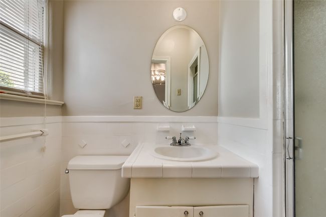 Full bath with vanity, wainscoting, and a shower with shower door | Image 25