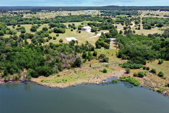 Overhead lake shore view facing eastward towards prime build site/RV pad, shop, and modular home | Image 33
