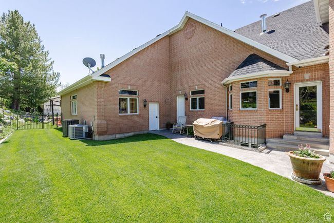 Back of house with a patio, brick siding, entry steps, and roof with shingles | Image 88