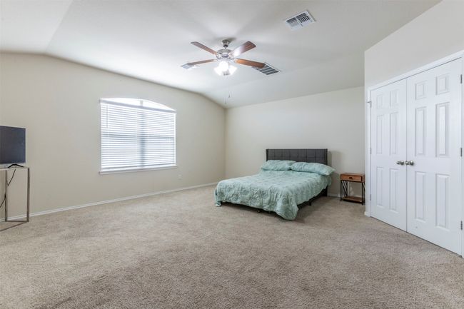 Bedroom featuring carpet floors, visible vents, and lofted ceiling | Image 12