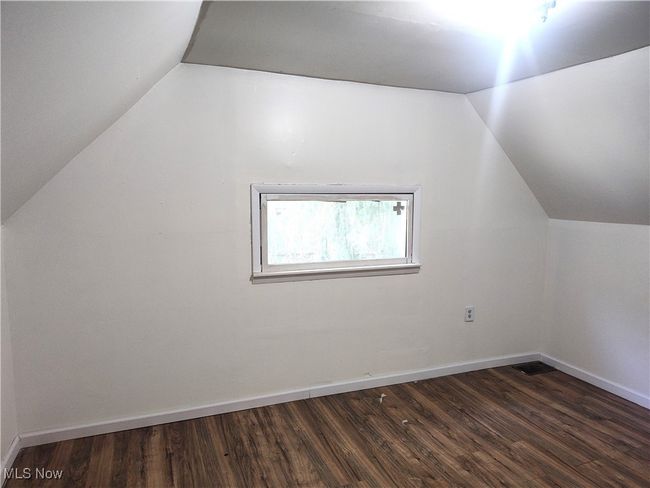 Bonus room featuring vaulted ceiling, dark wood-style floors, and baseboards | Image 46