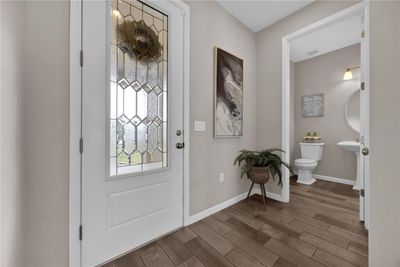 Upgraded front door & and wood like porcelain tile throughout | Image 3