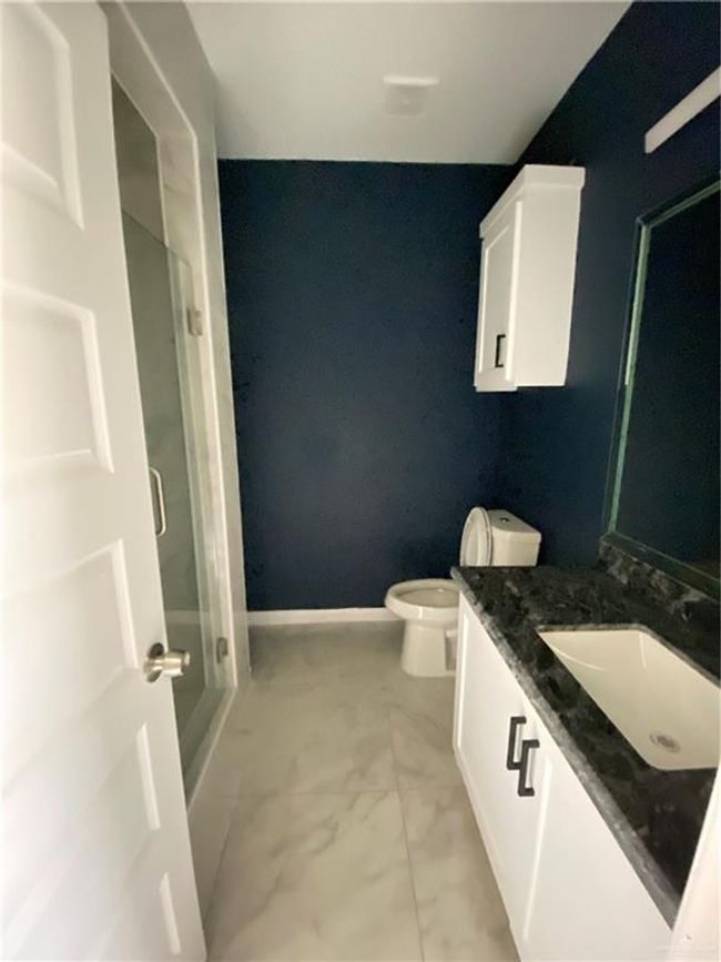 Full bathroom featuring a shower stall, vanity, and marble finish flooring | Image 15