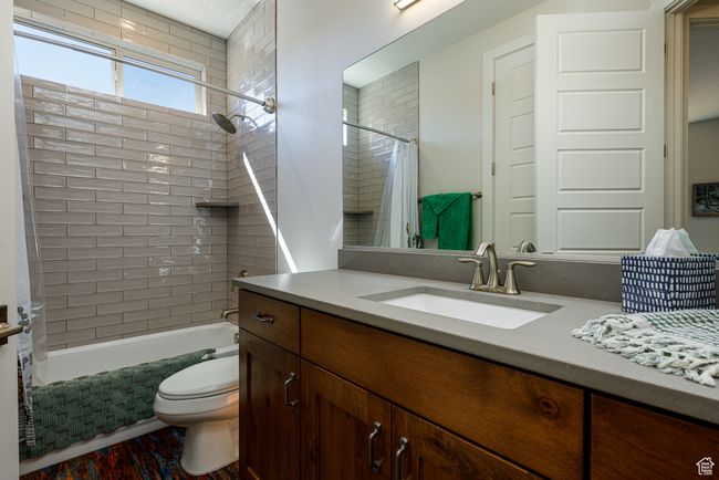 Main full bath featuring toilet, vanity, and shower / bath combination with curtain | Image 28