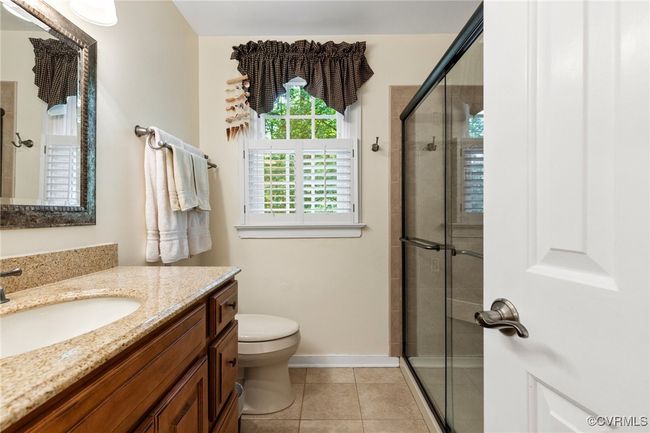 Bathroom featuring vanity, a stall shower, and tile patterned flooring | Image 36