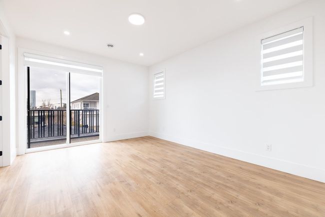 Empty room with light wood-style flooring and recessed lighting | Image 30