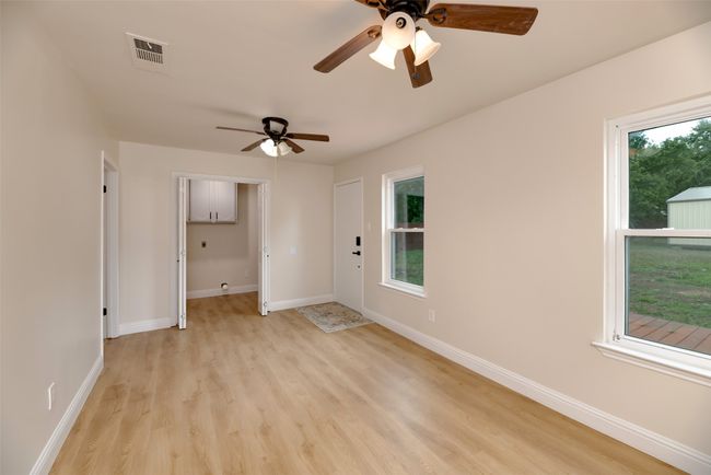 Unfurnished room with ceiling fan, light wood-style flooring, and baseboards | Image 22