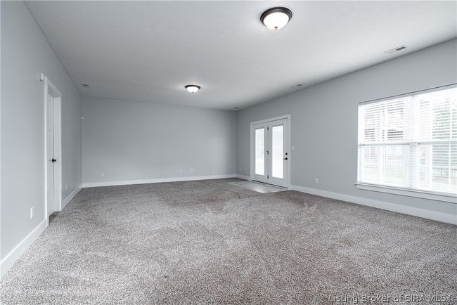 Sprawling family room on the lower level with lots of windows and walk out to lower level patio! | Image 28