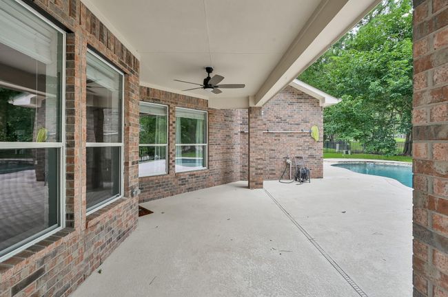 Just outside, the backyard opens to an expansive patio — perfect for lounging by the pool, grilling, and entertaining. | Image 39